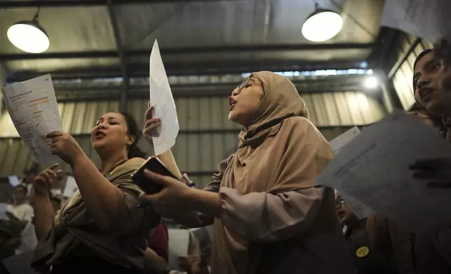 Hanifa Aulia, center, sings during a gathering of "Nyanyi Bareng Jakarta" or "Singing Together Jakarta" community in Jakarta, Indonesia, Saturday, July 19, 2025. (AP Photo/Dita Alangkara)