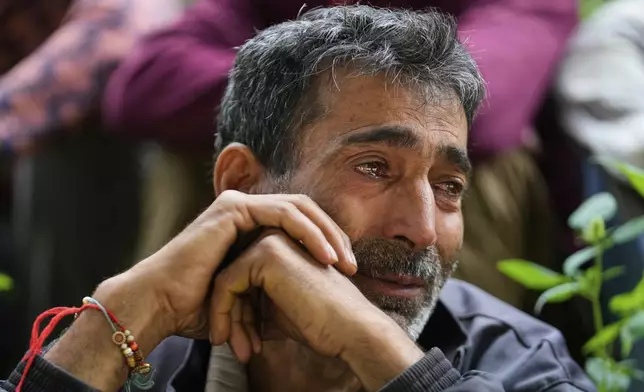 Hari Chand mourns the death of his wife during flash floods in Chositi village, in Kishtwar district, Indian-controlled Kashmir, Friday, Aug. 15, 2025. (AP Photo/Channi Anand)