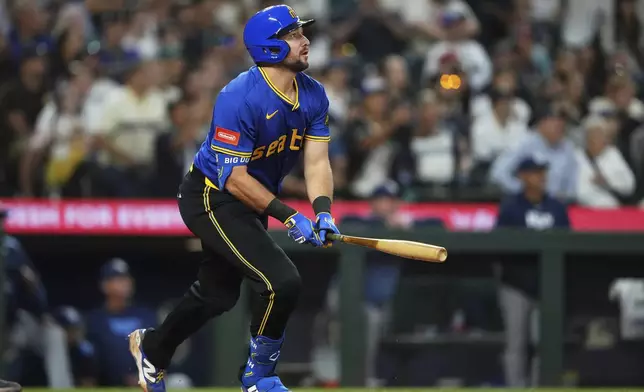 Seattle Mariners' Cal Raleigh watches his three-run home run against the Tampa Bay Rays during the eighth inning of a baseball game Friday, Aug. 8, 2025, in Seattle. (AP Photo/Lindsey Wasson)