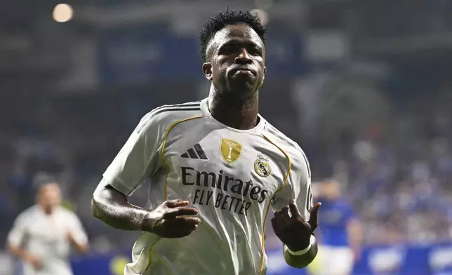 Real Madrid's Vinicius Junior celebrates after assisting teammate Kylian Mbappe to score during a Spanish La Liga soccer match between Real Oviedo and Real Madrid at Carlos Tartiere stadium in Oviedo, Spain, Sunday, Aug. 24, 2025. (AP Photo/Miguel Oses)
