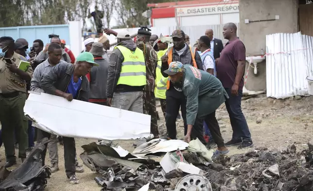 The debris of an airplane belonging to the African Medical and Research Foundation (AMREF) lies scattered after it crashed into a residential building in the Mwihoko area of Ruiru, in Kiambu County, Kenya, Thursday, Aug. 7, 2024. (AP Photo/Patrick Ngugi)