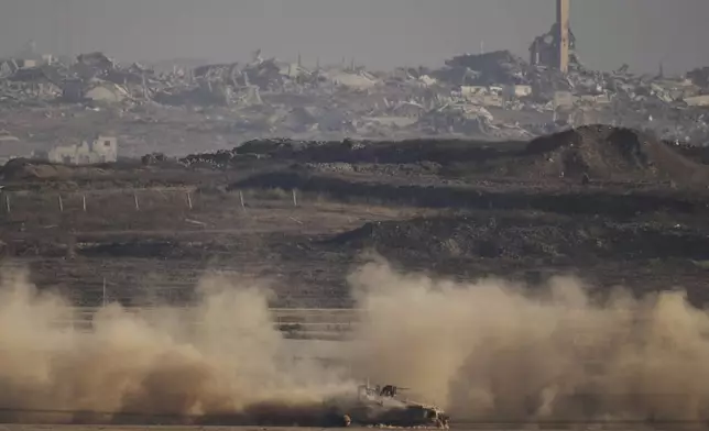 An Israeli armoured personnel carrier (APC) moves through the Israeli-Gaza border, as seen from southern Israel, Monday, Aug. 25, 2025. (AP Photo/Leo Correa)