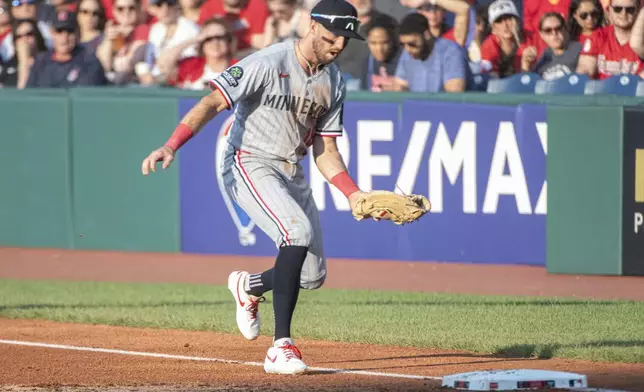Minnesota Twins' Kody Clemens runs to first base to put out Cleveland Guardians' Angel Martinez during the first inning of a baseball game, Friday, Aug. 1, 2025, in Cleveland. (AP Photo/Phil Long)