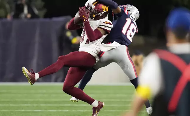 Washington Commanders cornerback Bobby Price (37) and New England Patriots wide receiver Kyle Williams (18) reach for a pass during the first half of an NFL preseason football game Friday, Aug. 8, 2025, in Foxborough, Mass. (AP Photo/Charles Krupa)
