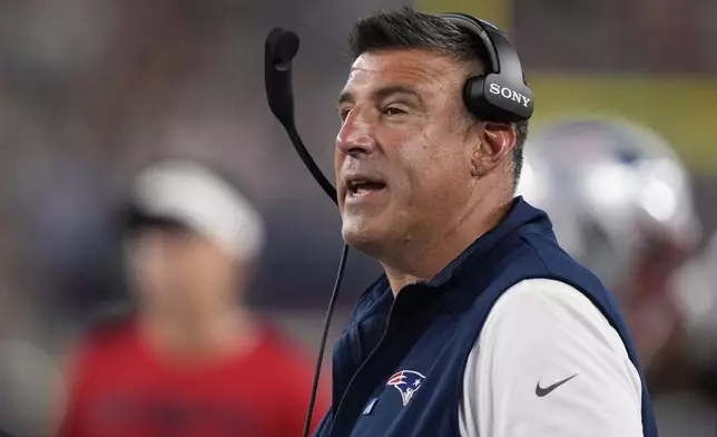 New England Patriots head coach Mike Vrabel stands on the sideline during the first half of an NFL preseason football game against the Washington Commanders Friday, Aug. 8, 2025, in Foxborough, Mass. (AP Photo/Charles Krupa)