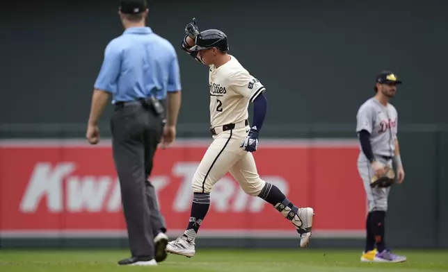 Minnesota Twins' Brooks Lee (2) runs the bases after hitting a grand slam during the third inning of a baseball game against the Detroit Tigers, Sunday, Aug. 17, 2025, in Minneapolis. (AP Photo/Abbie Parr)