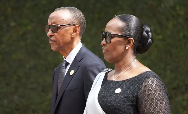 FILE - Rwandan President Paul Kagame, left, and his wife, first lady Jeannette Kagame arrive for a ceremony to mark the 30th anniversary of the Rwandan genocide, held at the Kigali Genocide Memorial, in Kigali, Rwanda, Sunday, April 7, 2024. (AP Photo/Brian Inganga, File)