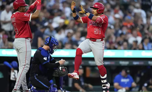 Los Angeles Angels' Gustavo Campero, right, celebrates with teammate Christian Moore, who also scored, after hitting a two-run home run during the fifth inning of a baseball game against the Detroit Tigers, Friday, Aug. 8, 2025, in Detroit. (AP Photo/Ryan Sun)