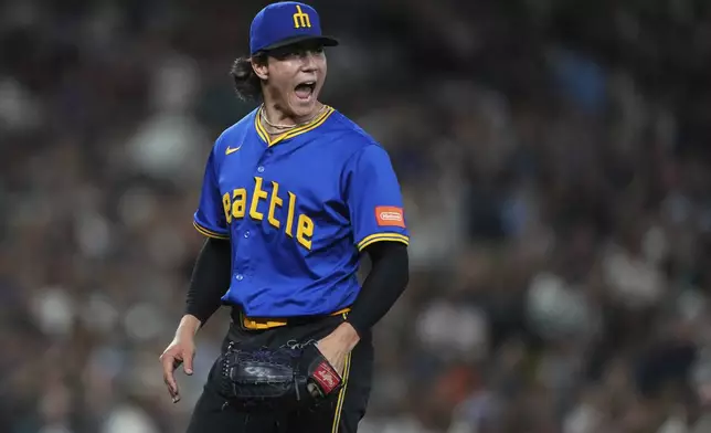 Seattle Mariners starting pitcher Bryan Woo reacts after Athletics' Lawrence Butler hit into a double play to end the top of the seventh inning of a baseball game Friday, Aug. 22, 2025, in Seattle. (AP Photo/Lindsey Wasson)