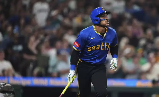 Seattle Mariners' Josh Naylor watches his solo home run off of Athletics pitcher Elvis Alvarado during the seventh inning of a baseball game Friday, Aug. 22, 2025, in Seattle. (AP Photo/Lindsey Wasson)