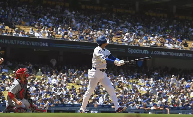 Los Angeles Dodgers' Shohei Ohtani, right, heads to first for a two-run home run and his 1,000th hit as St. Louis Cardinals catcher Pedro Pages watches during the third inning of a baseball game Wednesday, Aug. 6, 2025, in Los Angeles. (AP Photo/Mark J. Terrill)