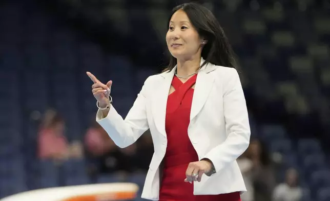 USA Gymnastics president Li Li Leung walks on stage after the senior men's finals of the U.S. Gymnastics Championships in New Orleans, Saturday, Aug. 9, 2025. (AP Photo/Gerald Herbert)