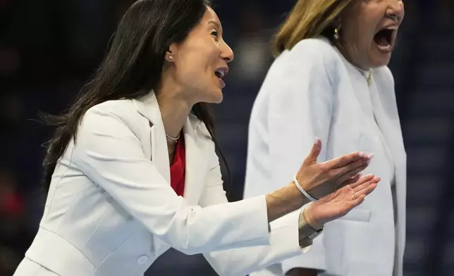 USA Gymnastics president Li Li Leung walks on stage after the senior men's finals of the U.S. Gymnastics Championships in New Orleans, Saturday, Aug. 9, 2025. (AP Photo/Gerald Herbert)