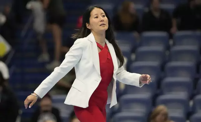 USA Gymnastics president Li Li Leung walks on stage after the senior men's finals of the U.S. Gymnastics Championships in New Orleans, Saturday, Aug. 9, 2025. (AP Photo/Gerald Herbert)