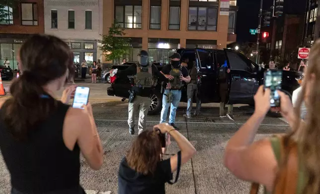 Department of Homeland Security Investigations agents detain a person at a checkpoint as they join Washington Metropolitan Police Department officers to conduct traffic checks along 14th Street in northwest Washington, Wednesday, Aug. 13, 2025, in Washington. (AP Photo/Jose Luis Magana)