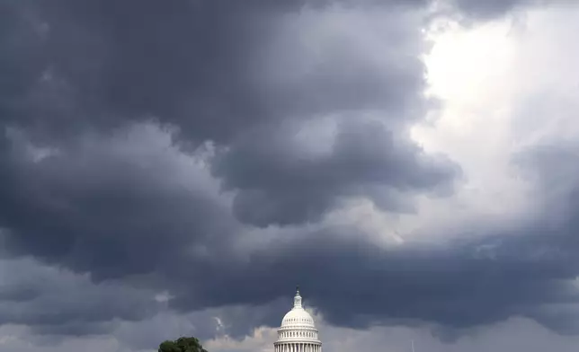Stormy skies are seen over the U.S. Capitol from the National Mall, Thursday, August 14, 2025, in Washington. (AP Photo/Jacquelyn Martin)