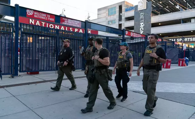 Drug Enforcement Administration agents patrol outside of the Nationals Park during a baseball game in Washington, Thursday, Aug. 14, 2025. (AP Photo/Jose Luis Magana)