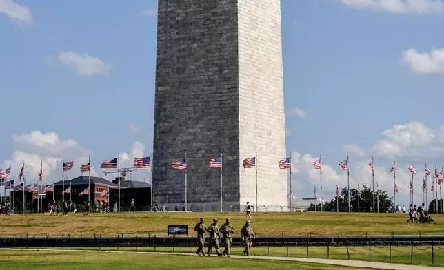 Members of the District of Columbia National Guard patrol along the National Mall, Saturday, Aug. 16, 2025, in Washington. (AP Photo/Julia Demaree Nikhinson)
