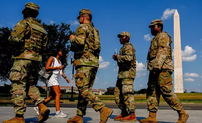 Members of the District of Columbia National Guard patrol along the National Mall, Saturday, Aug. 16, 2025, in Washington. (AP Photo/Julia Demaree Nikhinson)