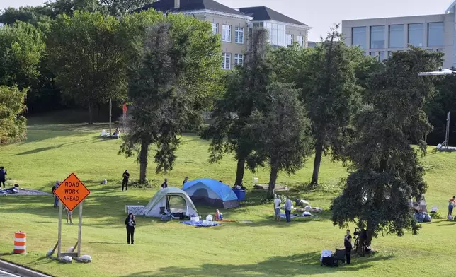 Camping tents seen at a homeless encampment near the Lincoln memorial, as people clean up in advance of a 10 a.m. vacate order from the city, Thursday, August 14, 2025, in Washington. (AP Photo/Jacquelyn Martin)