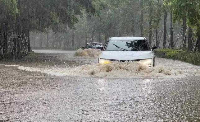 Streets of the capital city, Hanoi, are flooded due to heavy rain after Typhoon Kajiki passed through Vietnam, Tuesday, Aug. 26, 2025. (AP Photo/Hau Dinh)