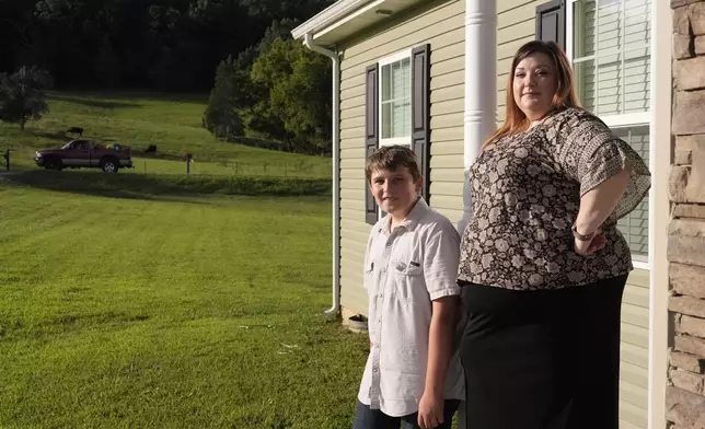 Heather Colley, right, poses with her son, Michah, outside their home Wednesday, Aug. 27, 2025, in Talbott, Tenn. (AP Photo/George Walker IV)