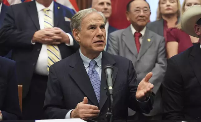 Texas Gov. Greg Abbott speaks to the media following a bill signing as Texas senators debate a bill on a redrawn U.S. congressional map during a special session in the Senate Chamber at the Texas Capitol in Austin, Texas, Friday, Aug. 22, 2025. (AP Photo/Eric Gay)
