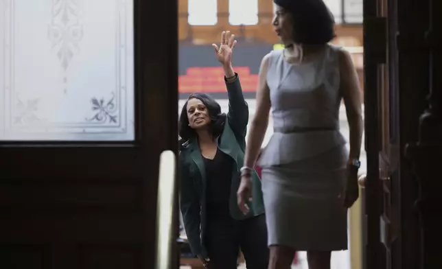 Texas state Rep. Nicole Collier, left, waves past Texas state Sen. Carol Alvarado, right, to supporters outside of the House Chamber where she refuses to leave due to a required law enforcement escort, Tuesday, Aug. 19, 2025, in Austin, Texas. (AP Photo/Eric Gay)