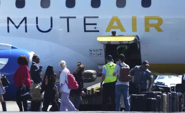 Texas Democratic lawmakers return to Texas after leaving two weeks ago to block a vote on a redrawn redistricting map, Monday, Aug. 18, 2025, in Austin, Texas. (AP Photo/Eric Gay)