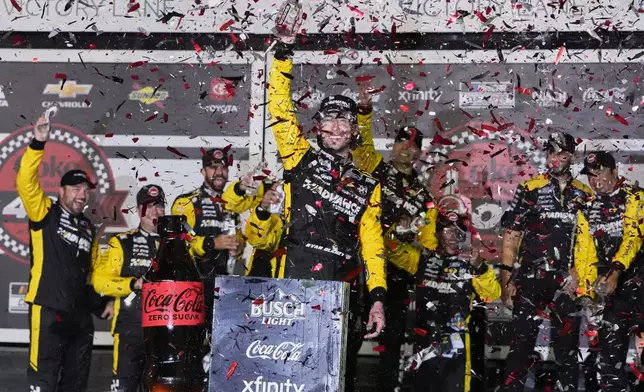 Ryan Blaney, center, celebrates in Victory Lane after winning a NASCAR Cup Series auto race at Daytona International Speedway, Saturday, Aug. 23, 2025, in Daytona Beach, Fla. (AP Photo/John Raoux)