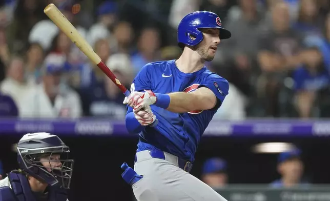 Chicago Cubs' Kyle Tucker follows the flight of his RBI single off Colorado Rockies relief pitcher Jimmy Herget in the sixth inning of a baseball game Saturday, Aug. 30, 2025, in Denver. (AP Photo/David Zalubowski)