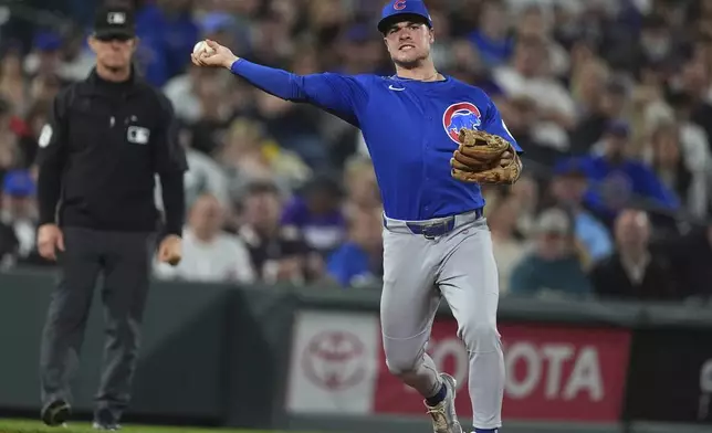Chicago Cubs third baseman Matt Shaw throws to first base to put out Colorado Rockies' Hunter Goodman to end the eighth inning of a baseball game Saturday, Aug. 30, 2025, in Denver. (AP Photo/David Zalubowski)