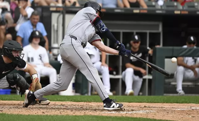 Cleveland Guardians' Kyle Manzardo hits a home run during the seventh inning of a baseball game against the Chicago White Sox, Sunday, Aug. 10, 2025, in Chicago. (AP Photo/Matt Marton)