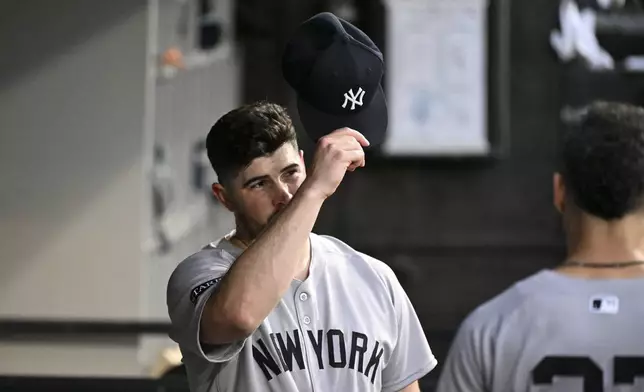 New York Yankees pitcher Carlos Rodón tips his cap to fans during the first inning of a baseball game against the Chicago White Sox, Friday, Aug. 29, 2025, in Chicago. (AP Photo/Matt Marton)
