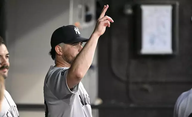 New York Yankees pitcher Carlos Rodón waves to fans during the first inning of a baseball game against the Chicago White Sox, Friday, Aug. 29, 2025, in Chicago. (AP Photo/Matt Marton)