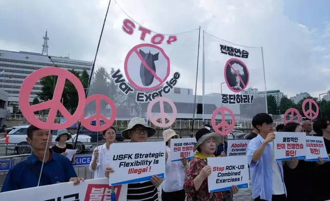 South Korean protesters stage a rally to oppose the joint military exercises, Ulchi Freedom Shield or UFS, between the U.S. and South Korea in front of the presidential office in Seoul, South Korea, Monday, Aug. 18, 2025. The banners read "Stop the military exercise between the U.S. and South Korea." (AP Photo/Ahn Young-joon)