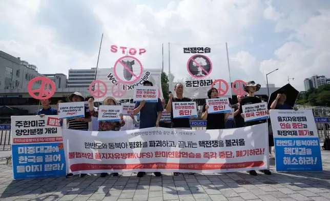 South Korean protesters stage a rally to oppose the joint military exercises, Ulchi Freedom Shield or UFS, between the U.S. and South Korea in front of the presidential office in Seoul, South Korea, Monday, Aug. 18, 2025. The banners read "Stop the military exercise between the U.S. and South Korea." (AP Photo/Ahn Young-joon)