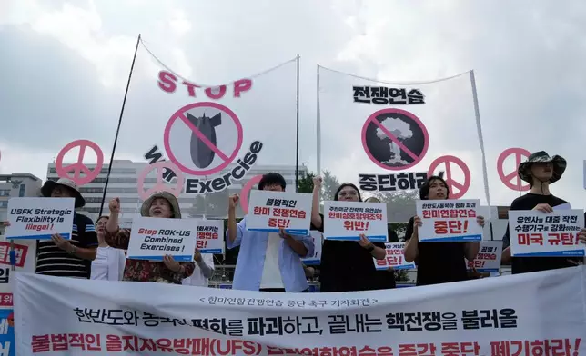 South Korean protesters stage a rally to oppose the joint military exercises, Ulchi Freedom Shield or UFS, between the U.S. and South Korea in front of the presidential office in Seoul, South Korea, Monday, Aug. 18, 2025. The banners read "Stop the military exercise between the U.S. and South Korea." (AP Photo/Ahn Young-joon)