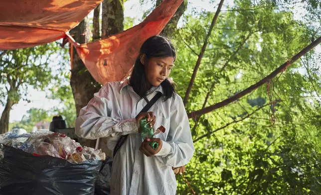 Isela Santiago Morales, who works with her family collecting PET bottles, sorts recyclables at the municipal dump in Axtla de Terrazas, Mexico, Wednesday, Aug. 20, 2025. (AP Photo/Mauricio Palos)