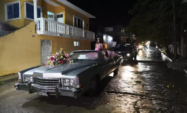 Isela Santiago Morales rides for her 15th birthday party at a stadium in Axtla de Terrazas, Mexico, Saturday, Aug. 23, 2025, organized by the community after her father's social media appeal drew support following her first sparsely attended party. (AP Photo/Mauricio Palos)