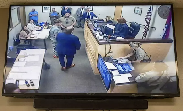 Andrew James McGann, charged with two counts of capital murder, is seen on the video monitor as he appears in front of District Judge Terra Stephenson for his bond hearing at the Washington County Detention Center. Friday, Aug, 1, 2025, in Fayetteville, Ark. (AP Photo/Michael Woods)