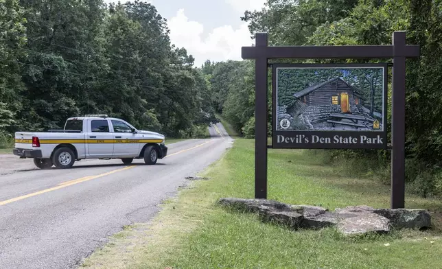 An Arkansas Park Ranger patrols the South Entrance of Devils Den State Park Monday, July 28, 2025, in West Fork, Ark. Police in Arkansas are searching for a suspect in the deaths of a couple who investigators said were attacked while on a wooded walking trail with their two young daughters. (AP Photo/Michael Woods)