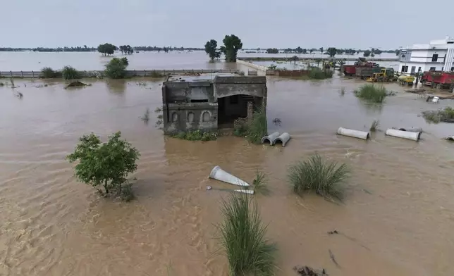 Submerged home is seen after torrential rains along a highway on the outskirts of Narowal, Pakistan, Wednesday, Aug. 27, 2025. (AP Photo/Jahan Zab)