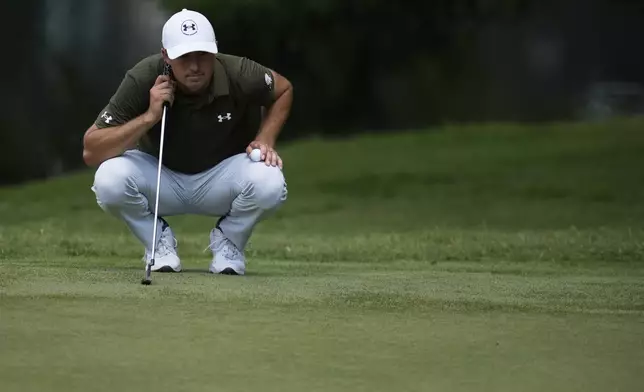 Jordan Spieth eyes a putt on the fourth green during the second round of the St. Jude Championship golf tournament Friday, Aug. 8, 2025, in Memphis, Tenn. (AP Photo/George Walker IV)