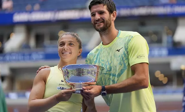 FILE - Sara Errani, of Italy, and Andrea Vavassori, of Italy, hold up the championship trophy after defeating Taylor Townsend, of the United States, and Donald Young, of the United States, in the mixed doubles final of the U.S. Open tennis championships, Thursday, Sept. 5, 2024, in New York. (AP Photo/Julia Nikhinson, File)