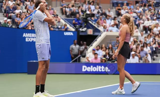 Daniil Medvedev, left, and his partner Mirra Andreeva react during a mixed doubles match at the U.S. Open tennis championships, Tuesday, Aug. 19, 2025, in New York. (AP Photo/Yuki Iwamura)