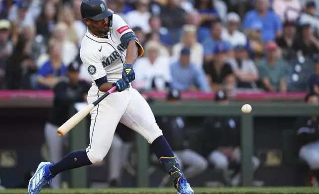 Seattle Mariners' Julio Rodriguez hits a three-run home run against the Chicago White Sox during the second inning of a baseball game Wednesday, Aug. 6, 2025, in Seattle. (AP Photo/Lindsey Wasson)