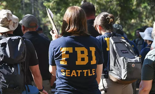 This photo provided by FBI Seattle shows FBI and other law enforcement agencies participating in the search for Travis Decker, who was charged with murder and kidnapping, at Rock Island Campground near Leavenworth, Wa. on Monday, August. 25, 2025. (FBI via AP)