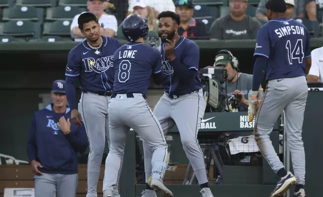 Tampa Bay Rays' Brandon Lowe (8) celebrates with Junior Caminero, center right, after hitting a two run-home run during the second inning of a baseball game against the Athletics, Wednesday, Aug. 13, 2025, in West Sacramento, Calif. (AP Photo/Scott Marshall)