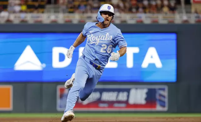 Kansas City Royals' Adam Frazier rounds third base en route to scoring against the Minnesota Twins on a Jonathan India single in the ninth inning of a baseball game Saturday, Aug. 9, 2025, in Minneapolis. (AP Photo/Bruce Kluckhohn)